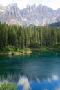 Blue lake Lago di Carezza in Dolomites on the outskirts of huge mountains