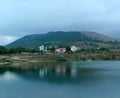 blue lake and mountain, houses by the lake, cottages in the highlands Royalty Free Stock Photo