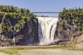 Blue lake and powerful waterfall Montmorency in Montmorency Falls Park, in Quebec Royalty Free Stock Photo