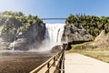 Blue lake and powerful waterfall Montmorency in Montmorency Falls Park, in Quebec Royalty Free Stock Photo