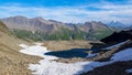 Blue lake surrounded by snow in the european alps. Tour De Mont Blanc, France Royalty Free Stock Photo