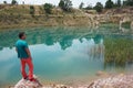 blue lake with water contaminated by mining activities at the Lousal mines in the municipality of Grandola. Watching man