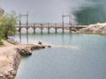 Blue lake with wooden tourist path bridge above cold water Royalty Free Stock Photo