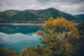 Blue lake and yellow bush in mountains