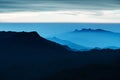 Blue landscape with mountains and morning fog. Cloudy sunrice