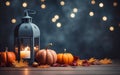 Blue lantern with burning candle on wooden floor decorated in autumnal style, pumpkins, maple leaves. Blurred bokeh lights. Royalty Free Stock Photo