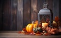 Blue lantern with burning candle on wooden floor decorated in autumnal style, pumpkins, maple leaves. Blurred bokeh lights. Royalty Free Stock Photo