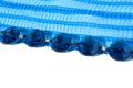 Blue large beads lie on a corrugated tape Royalty Free Stock Photo