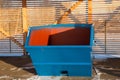 Blue large garbage container at winter day