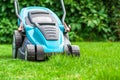 Blue lawn mower on green grass cut the grass Royalty Free Stock Photo