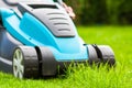 Blue lawn mower on green grass cut the grass Royalty Free Stock Photo