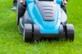 Blue lawn mower on green grass cut the grass Royalty Free Stock Photo