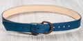 Blue leather belt with forged buckle Royalty Free Stock Photo