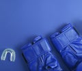 Blue leather boxing gloves and silicone cap for teeth Royalty Free Stock Photo