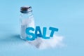 Blue letters spelling the word salt and salt shaker