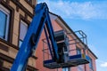 Blue lift basket on the background of the building