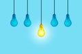 Blue light bulbs with glowing one yellow different light bulb idea hanging on blue background. Think creatively concept. New Royalty Free Stock Photo