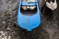 Blue and light colored fishing canoe resting on the sands of the river Royalty Free Stock Photo