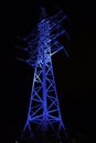 Blue light illumination of the power line support Royalty Free Stock Photo