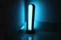 Blue light from a modern desk lamp. Indoor lights concept for home decor Royalty Free Stock Photo