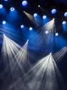 Blue light rays from the spotlight through the smoke at the theater or concert hall. Lighting equipment for a performance or show Royalty Free Stock Photo