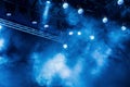 Blue light rays from the spotlight through the smoke at the theater or concert hall. Lighting equipment for a performance or show Royalty Free Stock Photo