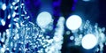 Blue lights bokeh from christmas holiday garlands, blurred festive background, abstract lights Royalty Free Stock Photo