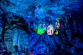 Dripstone cave, Reed Flute Cave, Ludi Yan, Guilin, Guangxi, China. Blue lilluminated rocks with small colorful part in cave.