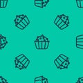 Blue line Cupcake icon isolated seamless pattern on green background. Vector