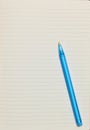 Blue lined paper with blue pen Royalty Free Stock Photo