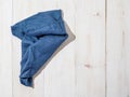 Blue linen kitchen towel or textile napkin on white wooden background. Royalty Free Stock Photo