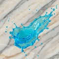 Blue liquid splash digitally rendered on a marble surface. The marble features light Royalty Free Stock Photo