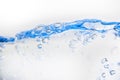 Blue lit water surface with wave and bubbles Royalty Free Stock Photo