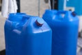 A blue 20 liter HPDE water container being refilled with purified H2O. The top cap already sealed with shrink wrap Royalty Free Stock Photo