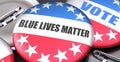 Blue lives matter and elections in the USA, pictured as pin-back buttons with American flag, to symbolize that Blue lives matter