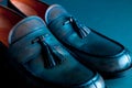 Blue loafer shoes on blue background. One pair. Close up