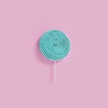 Blue lollipop candy on pink background