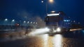 Blue Long Haul Semi-Truck with Cargo Trailer Full of Goods Travels At Night on the Freeway Road Royalty Free Stock Photo