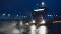 Blue Long Haul Semi-Truck with Cargo Trailer Full of Goods Travels At Night on the Freeway Road Royalty Free Stock Photo