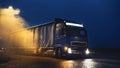 Blue Long Haul Semi-Truck with Cargo Trailer Full of Goods Travels At Night , Turning on Freeway Royalty Free Stock Photo