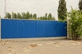 Blue long iron gates on the street