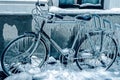 Blue look at ice icicles on a parked bicycle