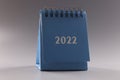 Blue loose leaf calendar 2022 on gray background Royalty Free Stock Photo