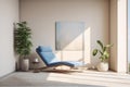 A blue lounge chair sits in the room opposite a large window. Calm abstract blue painting on a beige wall. A place for relaxation Royalty Free Stock Photo