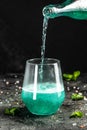 Blue low alcohol drink, chilled colorful beverages on rustic black background. summer party. Alcoholic drink concept. Freeze