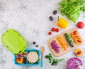 Blue lunch box with cover and ingredients on light background wi