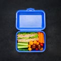 Blue Lunch Box with Sandwich and Vegetables Royalty Free Stock Photo