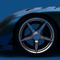 Blue Luxury Car Background with Beautiful Wheel and Brake Parts CloseUp. A Modern Car with a Blue Metallic Surface in Dim Studio. Royalty Free Stock Photo