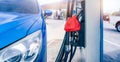 Blue luxury SUV car fueling at gas station. Refuel fill up with petrol gasoline. Petrol pump filling fuel nozzle in gas station. Royalty Free Stock Photo