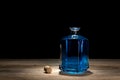 Blue magic potion on wooden table. Corked bottle of mysterious liquid. Royalty Free Stock Photo